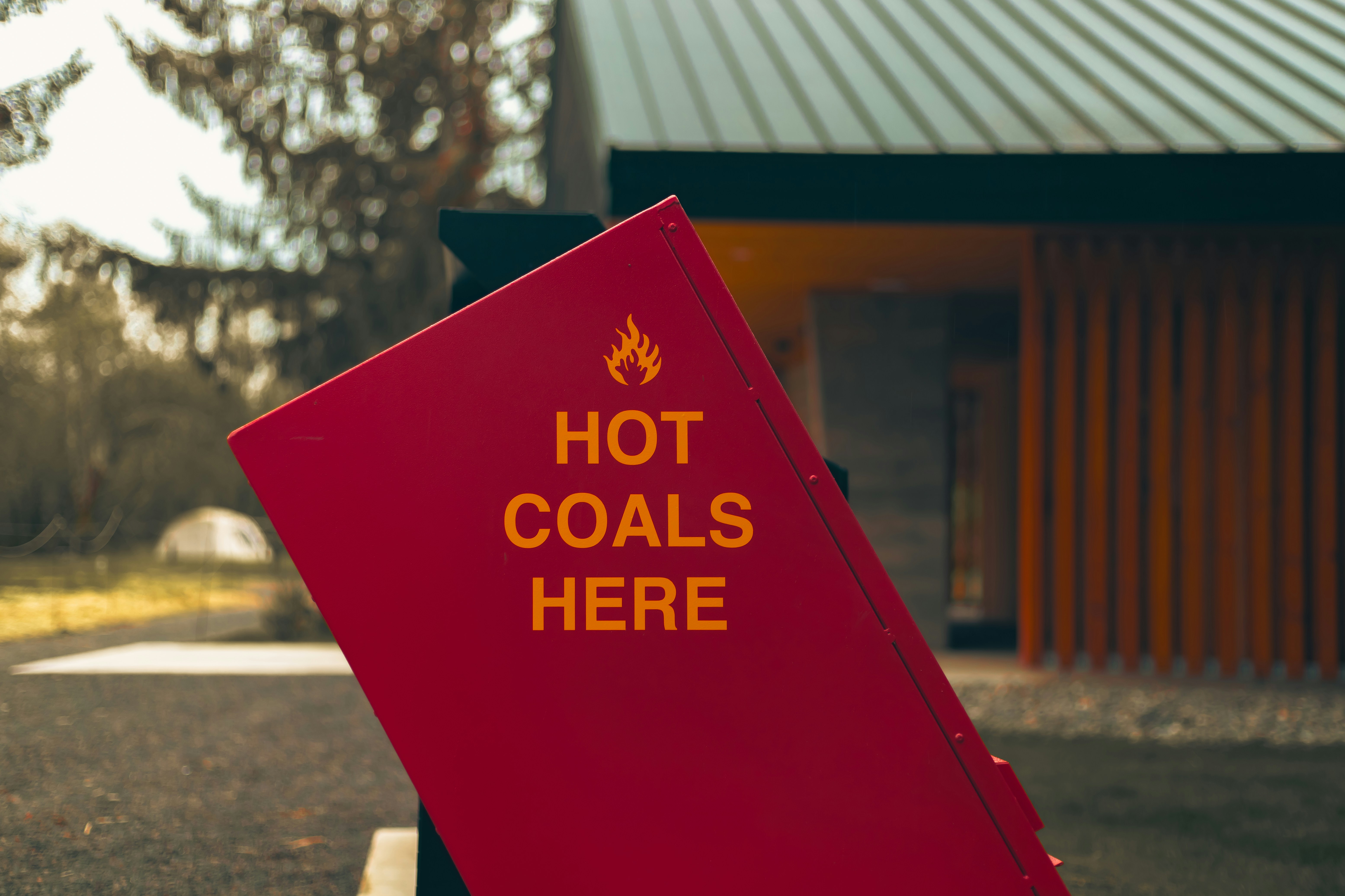 a red sign that says hot coals here